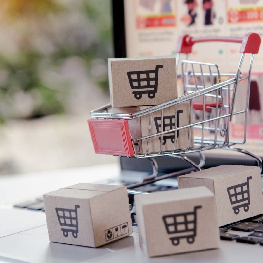 Shopping online. cardboard box with a shopping cart logo in a trolley on laptop keyboard. Shopping service on The online web. offers home delivery
